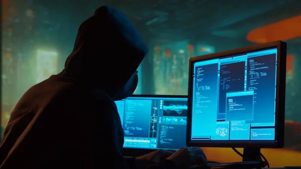 Computer Hacker in Hoodie. Obscured Dark Face. Hacker Attack, Virus Infected Software, Dark Web and Cyber Security concept.