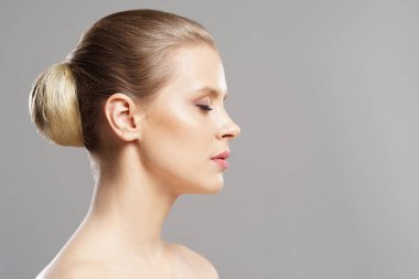 Close-up portrait of beautiful, fresh, healthy and sensual girl over isolated grey background