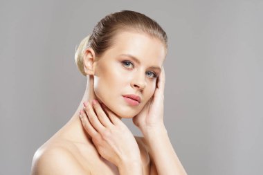 Close-up portrait of beautiful, fresh, healthy and sensual girl over isolated grey background