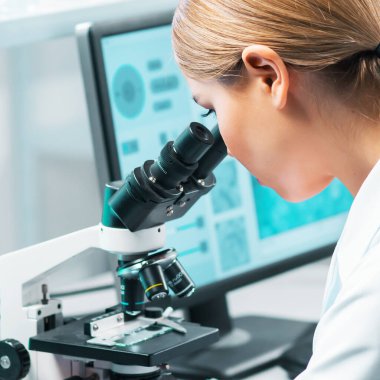 Professional scientist working on a vaccine in a modern scientific research laboratory. Genetic engineer workplace. Laboratory tools: microscope, test tubes, equipment. Future technology, healthcare