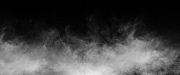 Abstract smoke texture over black background. Fog in the darkness.