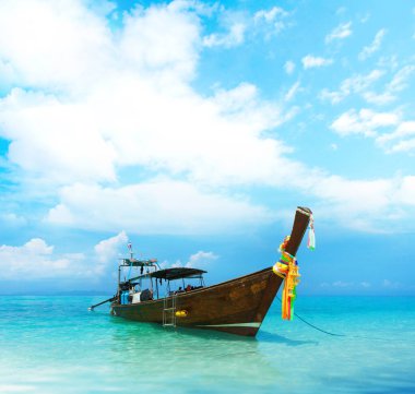 Thai traditional wooden longtail boat and beautiful sand beach in Thailand. The concept of traveling.