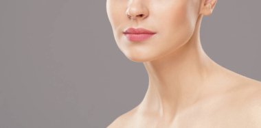 Close-up portrait of beautiful, fresh, healthy and sensual girl over isolated grey background