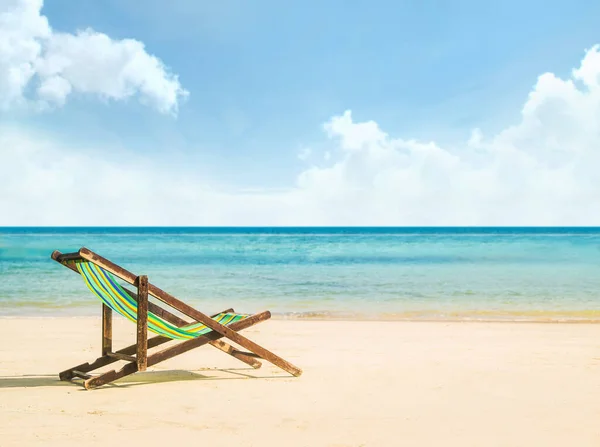 Lounge chairs on a tropical beach at summer. Traveling and vacation concept.