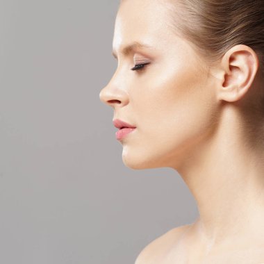 Close-up portrait of beautiful, fresh, healthy and sensual girl over isolated grey background