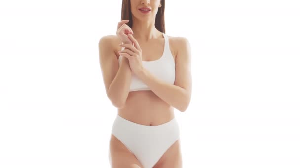 孤立した白い背景の上の白い下着の美しい女性 水着の健康な若い少女のクローズアップスタジオビデオ 健康とスキンケア ダイエット 化粧品のコンセプト — ストック動画