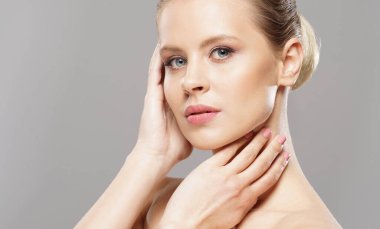 Close-up portrait of beautiful, fresh, healthy and sensual girl over isolated grey background