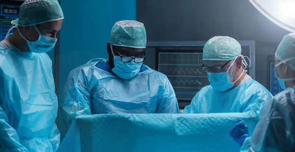 Різноманітна Команда Професійних Лікарів Проводить Хірургічну Операцію Сучасному Операційному Залі Ліцензійні Стокові Зображення