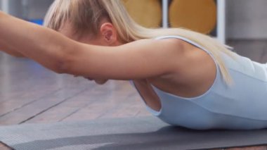 Spor giyimli genç ve sportif kız evde egzersiz yapıyor. Formda ve narin sarışın kadın spor ve spor için geliyor. Sağlık, yağ yakma ve sağlık konsepti.