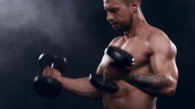 Siyah arka planda formda ve sportif vücut geliştirici. Halter kullanarak vücut geliştirici eğitimi. Spor ve spor kavramları.