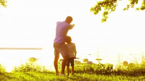 近海快乐的家庭农村的田野和树木 日落或日出时的暖色 有爱心的父母和漂亮的孩子爱情和养育子女概念 — 图库视频影像