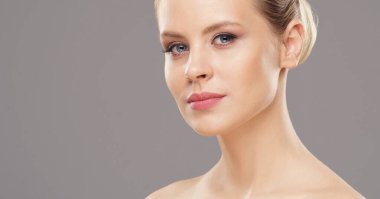 Close-up portrait of beautiful, fresh, healthy and sensual girl over isolated grey background