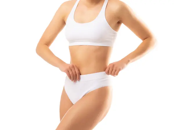 白い背景に白い水着の若く フィットし 美しい女性 ヘルスケア ダイエット スポーツ フィットネスコンセプト ストック画像