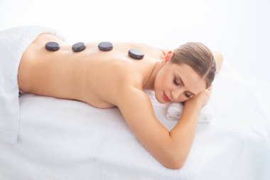 Beyaz arka planda masaj yaptıran genç bir kadın. Spa, sağlık ve dinlenme konsepti.