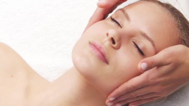 Kadın terapistten masaj tedavisi görüyor. Spa 'da masaj prosedürü. Sağlık, rahatlama, gençleşme ve sağIık kavramı.