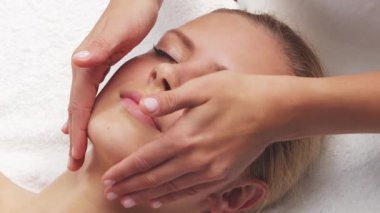 Kadın terapistten masaj tedavisi görüyor. Spa 'da masaj prosedürü. Sağlık, rahatlama, gençleşme ve sağIık kavramı.