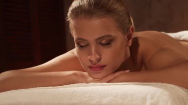 Kadın terapistten masaj tedavisi görüyor. Spa 'da masaj prosedürü. Sağlık, rahatlama, gençleşme ve sağIık kavramı.