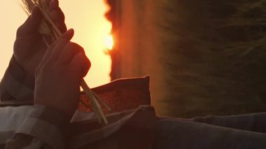 Farmer in front of a sunset agricultural landscape. Man in a countryside field. The concept of country life, food production, farming and country lifestyle.