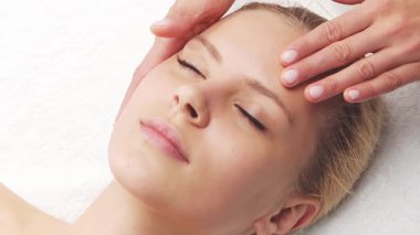 Kadın terapistten masaj tedavisi görüyor. Spa 'da masaj prosedürü. Sağlık, rahatlama, gençleşme ve sağIık kavramı.