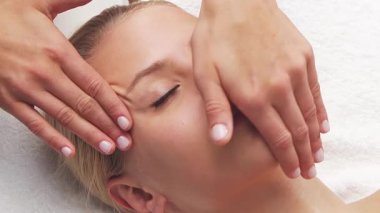 Kadın terapistten masaj tedavisi görüyor. Spa 'da masaj prosedürü. Sağlık, rahatlama, gençleşme ve sağIık kavramı.