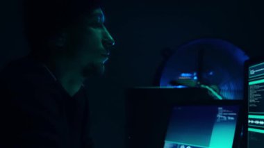 Aranan hackerlar virüs fidye yazılımını bodrumdaki bilgisayar ve dizüstü bilgisayarlarla kodluyorlar. Siber saldırı, sistem kırma ve kötü amaçlı yazılım kavramı.