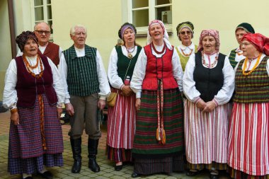 Vilnius, Lithuania - 26 May 2024: people in folk clothes singing in chorus at Vilnius on Lithuania clipart