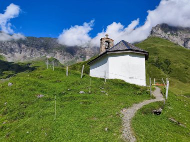 View at che church of Blackenalp over Engelberg on the Swiss alps clipart