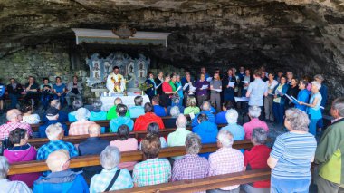 Wildkirchli, Switzerland - 14 July 2024: christian ceremony at the cave chapel of Wildkirchli on the Swiss alps clipart