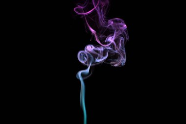 Multicolored smoke for aromatherapy and relaxation on black background, beautiful swirled puffs of smoke. Pink, purple and turquoise gradient colors of dense smoke, decorative multicolour smoke curls