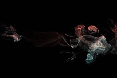 Multicolored smoke for aromatherapy and relaxation, black background, beautiful swirled puffs of smoke. Red, orange and turquoise gradient colors of dense smoke, decorative multi colour smoke curls