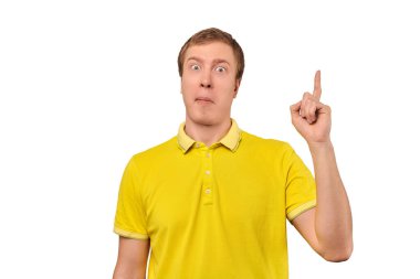 Funny young guy in yellow T-shirt with eureka gesture, man got idea, isolated on white background. Surprised man pointing index finger up, found solution to work task, remembered forgotten thought
