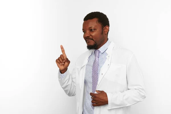 Happy black doctor man with small beard in white coat bright shirt got idea isolated on white background. Smiling adult black african american physician therapist portrait remembered forgotten concept