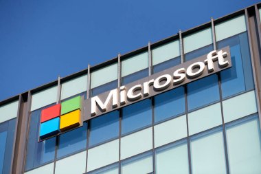 New Delhi - 08.12.2022 - Microsoft corporation brand logo on high rise glass building exterior, outdoor blue sky copy space. Microsoft software corporation head office logo on skyscraper