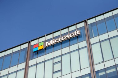 New Delhi - 08.12.2022 - Microsoft corporation brand logo on high rise glass building exterior, outdoor blue sky copy space. Microsoft software corporation head office logo on skyscraper