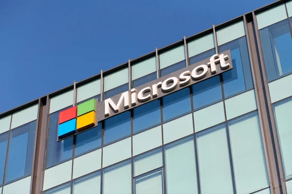 New Delhi - 08.12.2022 - Microsoft corporation brand logo on high rise glass building exterior, outdoor blue sky copy space. Microsoft software corporation head office logo on skyscraper