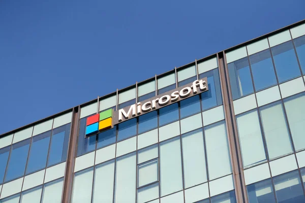 New Delhi - 08.12.2022 - Microsoft corporation brand logo on high rise glass building exterior, outdoor blue sky copy space. Microsoft software corporation head office logo on skyscraper