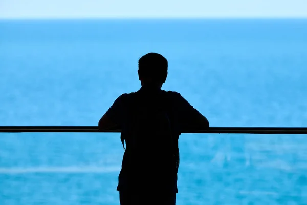 Genç Adamın Silueti Şeffaf Cam Tırabzanlara Yaslanmış Mavi Parlak Deniz — Stok fotoğraf