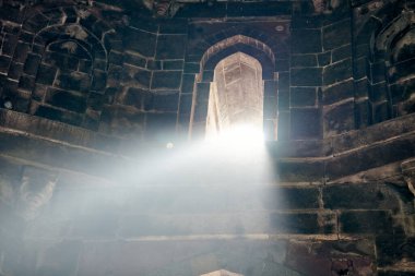 Hindistan 'ın Yeni Delhi kentindeki eski Hint mezarının penceresinden gelen ışık huzmesi, Hindistan' daki antik anıtın mistik ve gizemli atmosferi, eski mezarın içindeki güzel beyaz ışık huzmesi,