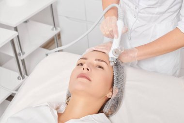 Kozmetik uzmanı yüz gazı sıvısı oksijen serumu epidermal kabuğunu gençleştirme için cilt bakımı, güzellik salonundaki yaşlanma karşıtı kozmetik prosedürü yapıyor. Güzellik uzmanı yüz bakımı yapıyor