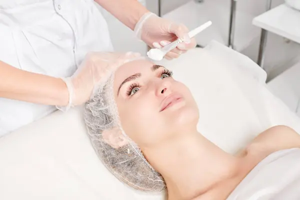 Beautician Puts Cream Mask Woman Face Rejuvenation Face Skin Aging — Stock Photo, Image