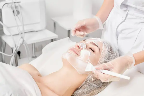 Beautician Applies Cosmetic Cream Mask Woman Face Rejuvenation Face Skin — Stock Photo, Image