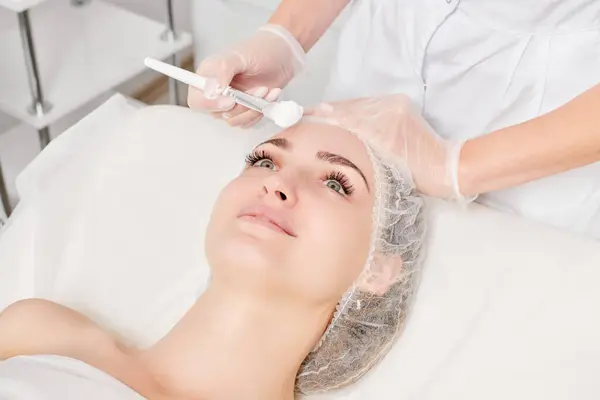 Beautician Puts Cream Mask Woman Face Rejuvenation Face Skin Aging — Stock Photo, Image