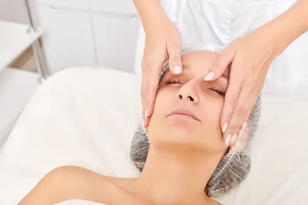 Beautician Massages Woman Face Skin Rejuvenation Aging Skincare Cosmetic Procedure Stock Photo