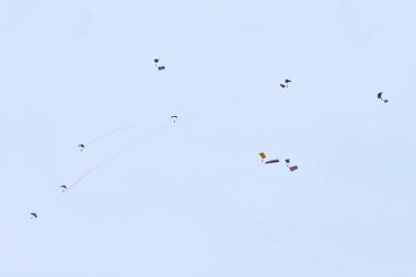 Airborne forces paratroopers soaring holding Flag of Russia and flags of military units, military exercise for celebration of Airborne Forces Day with formation landing, army airborne division descend clipart
