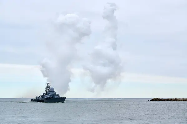 Stock image Russian warship fired decoy flares for self defense, sailing at sea military ship used anti missile protection throw heat seeking missiles off course, Russian sea power deployment demonstration