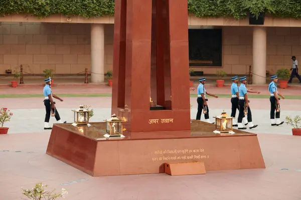 stock image New Delhi, India - 23.10.2022 - Indian marching soldiers of honor guard in Amar Jawan Jyoti at Amar Chakra in National War Memorial symbolizing a solemn tribute to fallen heroes