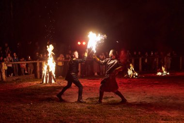 Kaliningrad, Rusya - 10.09.2022 - Karanlık zemine karşı iki yetenekli dövüşçü, canlı performansın yoğunluğunu ve heyecanını yakalarken,