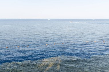 Sakin okyanus, yumuşak güneş ışığı altında uzanıyor. Horizon maviler içinde zar zor göze çarpıyor. Sahil görüş noktasından ideal sakin kaçış.