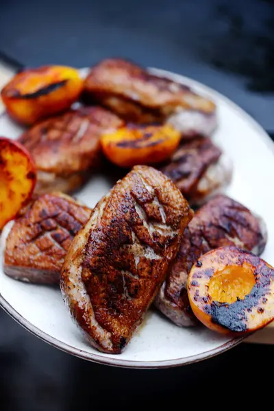 Duck Breast with peach on the outdoor grill.style rustic.selective focus