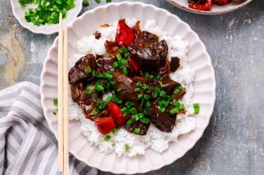 Chinese chicken liver with peppers and onions in the bowl .selective focus. top veiw